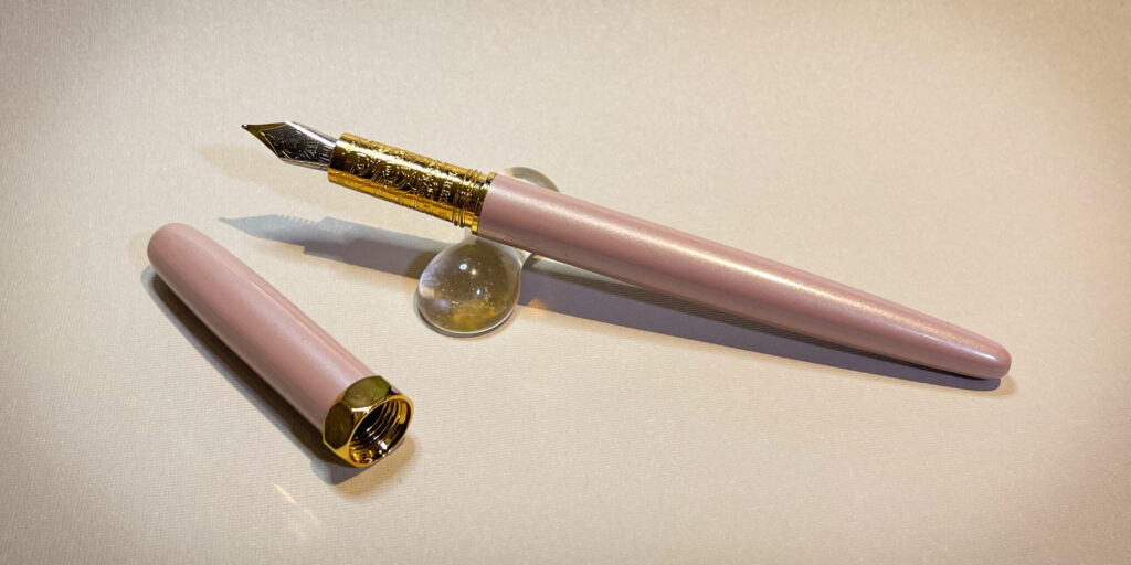 Ferris Wheel Press Bijou pen in Huffin Puff Pink colourway, showing the open pen and its cap